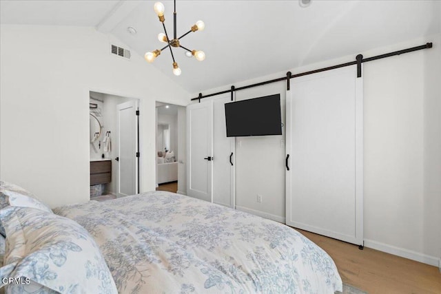 bedroom with a chandelier, a barn door, light hardwood / wood-style floors, and lofted ceiling with beams