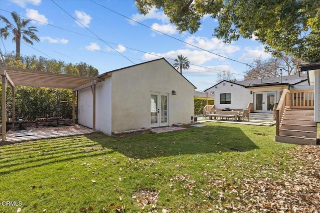 rear view of property featuring a pergola, a yard, a patio area, and french doors