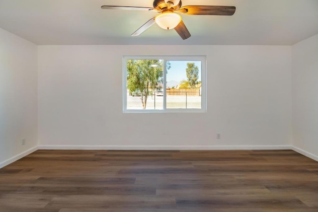 spare room featuring dark hardwood / wood-style floors and ceiling fan