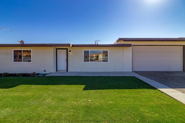 single story home featuring a garage and a front yard