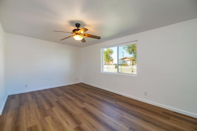 spare room featuring ceiling fan and dark hardwood / wood-style flooring