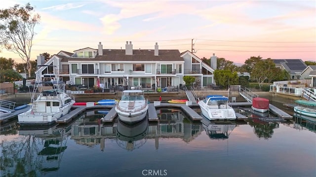 back house at dusk with a water view