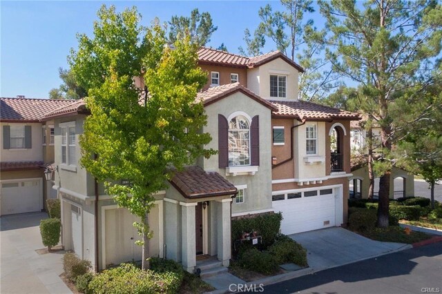 mediterranean / spanish-style house with a garage