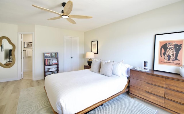 bedroom featuring ceiling fan, a closet, and light wood-type flooring