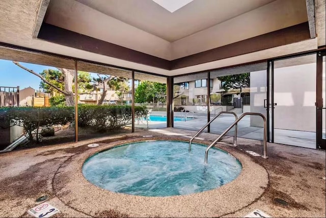 view of pool featuring a patio area and a hot tub