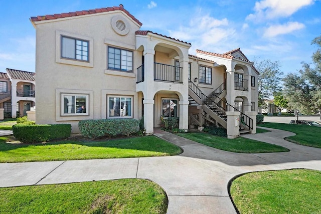 mediterranean / spanish-style house featuring a front yard