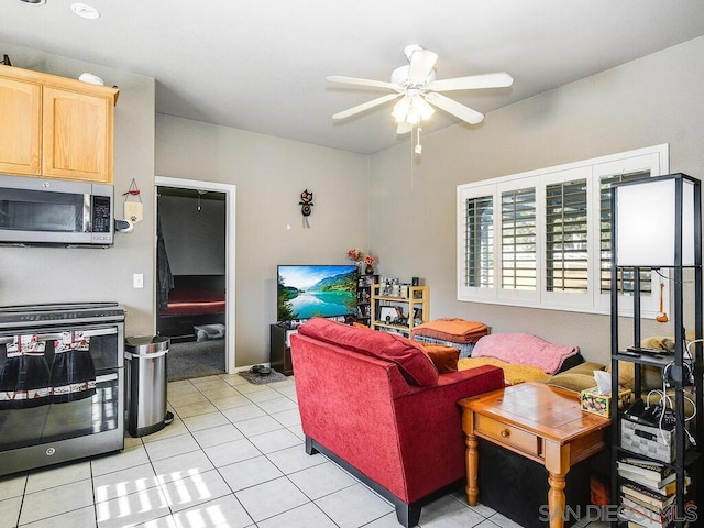 living room featuring ceiling fan and light tile patterned flooring