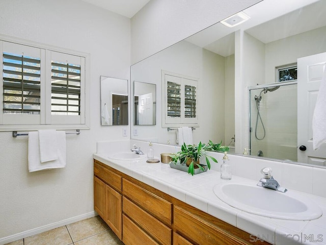 bathroom with tile patterned flooring, vanity, and an enclosed shower