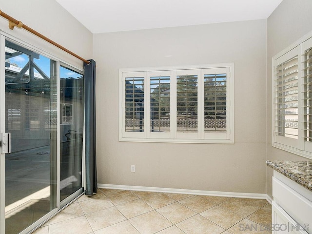 tiled empty room with a healthy amount of sunlight