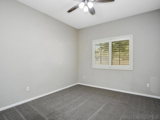 carpeted spare room featuring ceiling fan