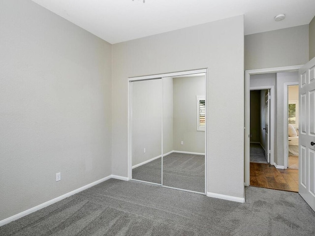 unfurnished bedroom featuring a closet and carpet