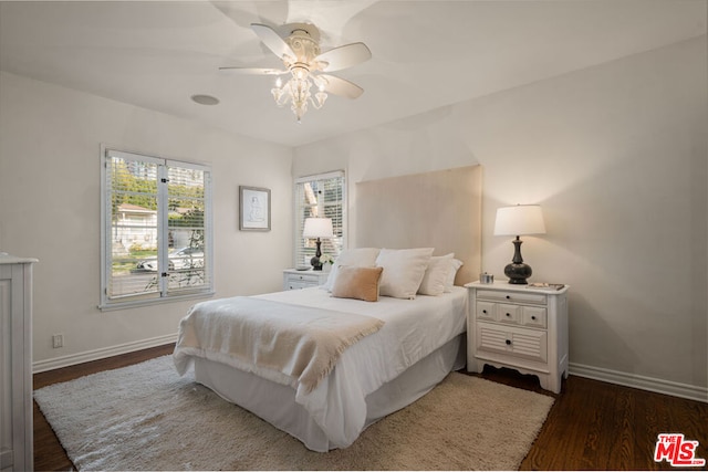 bedroom with ceiling fan and dark hardwood / wood-style flooring