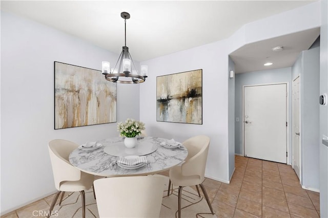 tiled dining area with an inviting chandelier