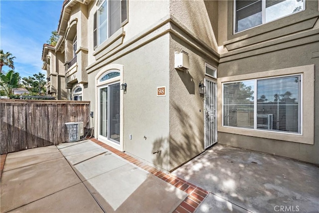 doorway to property featuring central air condition unit and a patio area