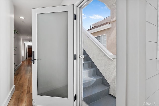 stairway with hardwood / wood-style floors