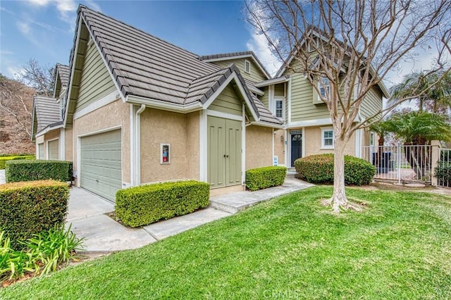 view of front of property featuring a garage and a front yard