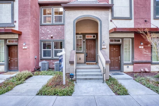 doorway to property featuring central AC unit