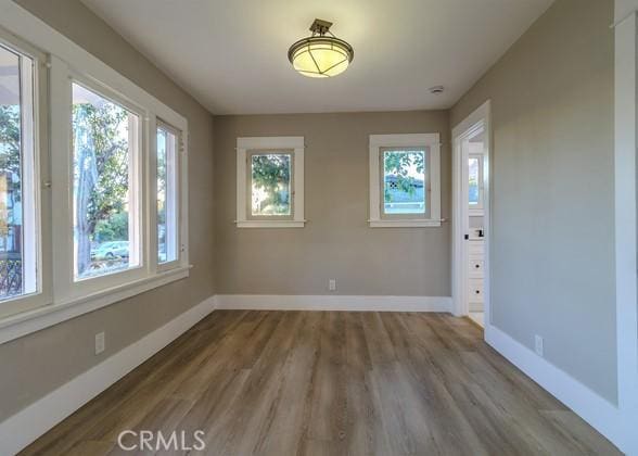 unfurnished room with hardwood / wood-style flooring