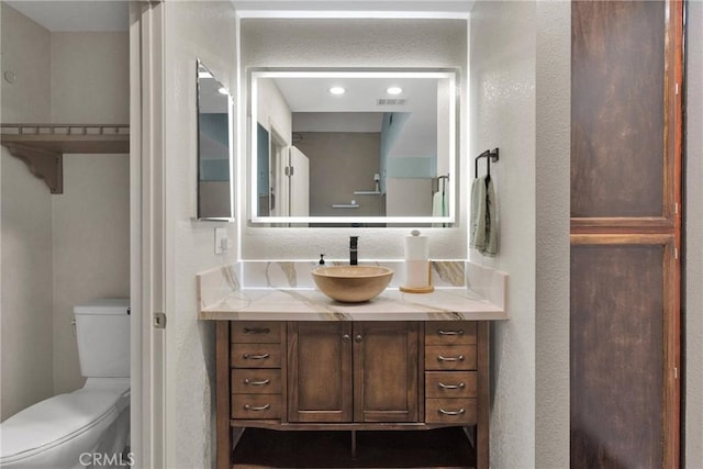 bathroom featuring vanity and toilet