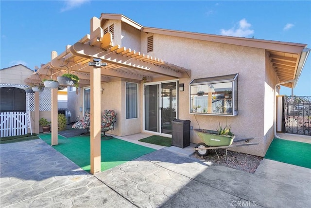 rear view of house with a pergola and a patio area