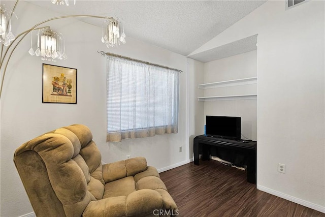 living room featuring lofted ceiling, dark hardwood / wood-style floors, a notable chandelier, and a textured ceiling