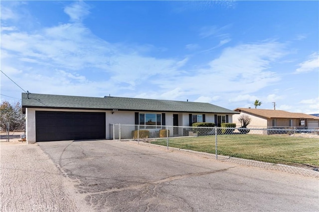 single story home featuring a garage and a front lawn