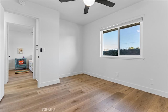 empty room featuring ceiling fan and light hardwood / wood-style floors