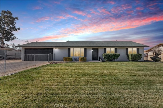 single story home with a yard and a garage