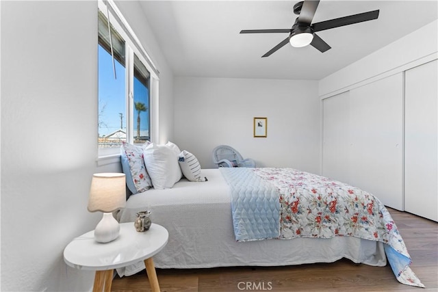 bedroom featuring hardwood / wood-style floors, ceiling fan, and a closet