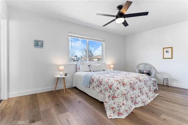 bedroom with light hardwood / wood-style floors and ceiling fan