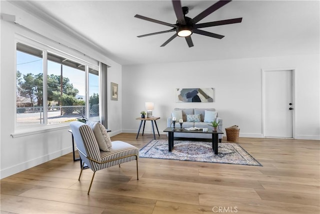 living area featuring ceiling fan and light hardwood / wood-style flooring