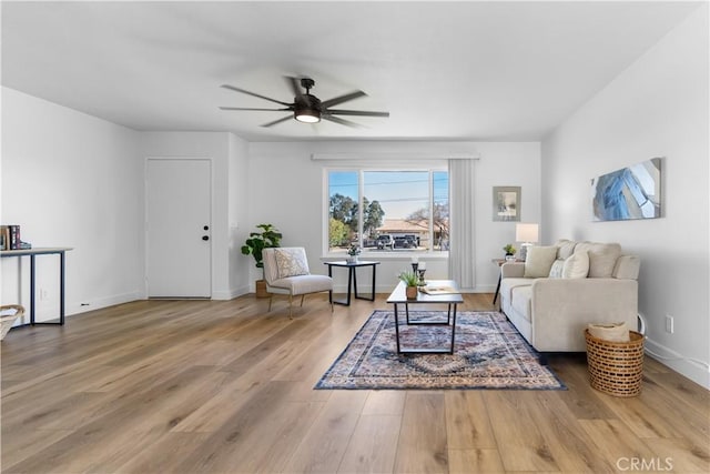 living room featuring ceiling fan and wood-type flooring