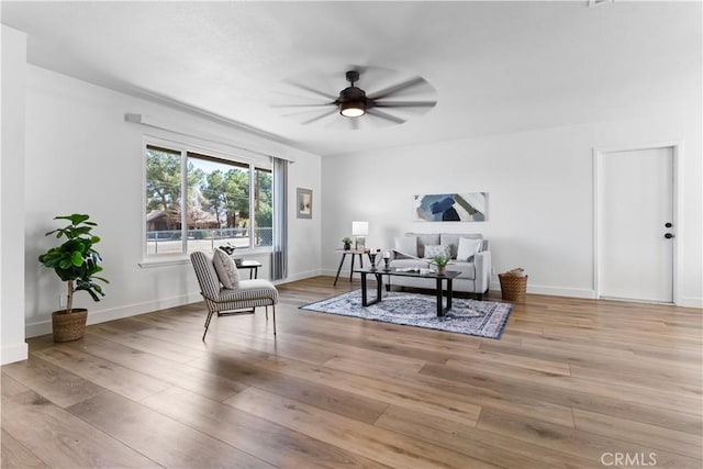 living area with ceiling fan and light wood-type flooring