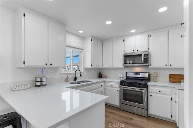 kitchen featuring white cabinets and appliances with stainless steel finishes