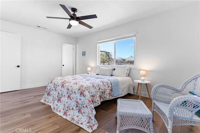 bedroom with hardwood / wood-style floors and ceiling fan