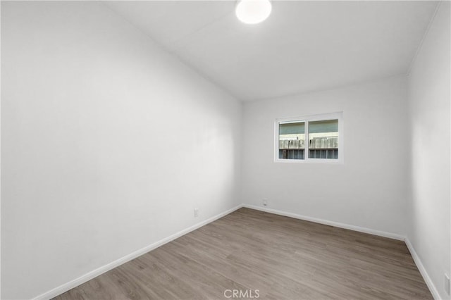 unfurnished room featuring hardwood / wood-style flooring