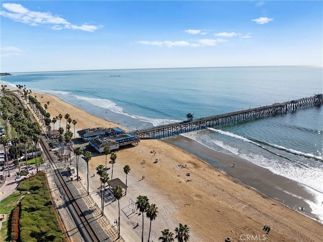 birds eye view of property with a water view and a beach view