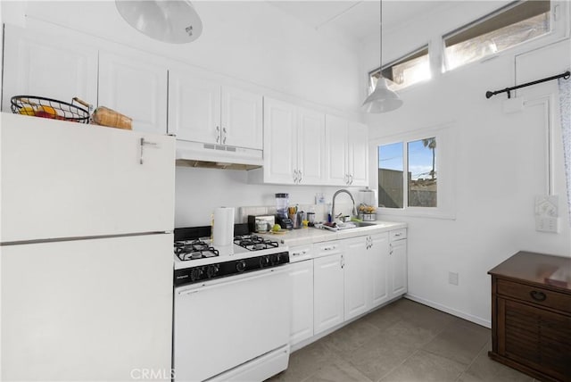 kitchen with hanging light fixtures, sink, white cabinets, and white appliances