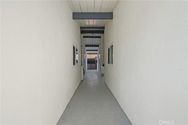 hall with beamed ceiling