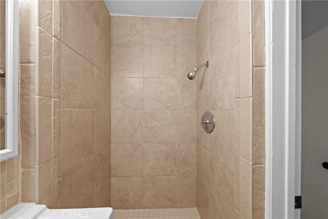 bathroom with a tile shower