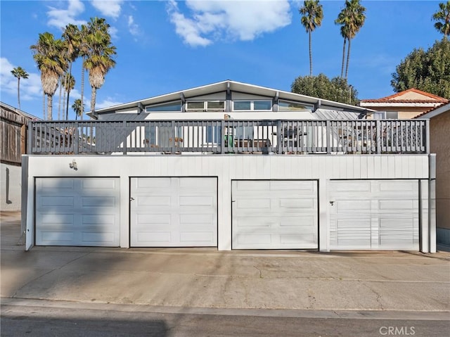 view of front of home with a garage and a balcony