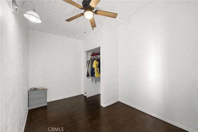 interior space with dark wood-type flooring, ceiling fan, wood ceiling, and vaulted ceiling