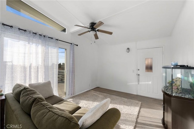 living room featuring ceiling fan and light hardwood / wood-style floors