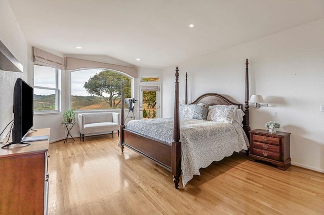 bedroom featuring vaulted ceiling and light wood-type flooring