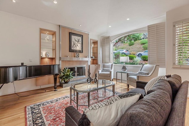 living room with hardwood / wood-style floors and built in features