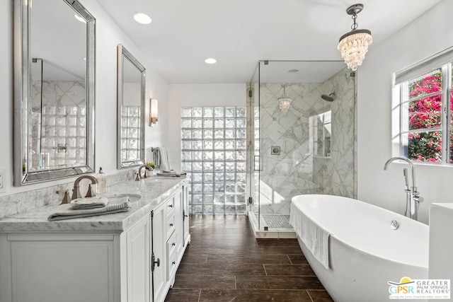 bathroom with vanity, a notable chandelier, and plus walk in shower