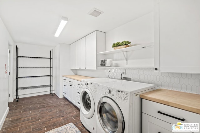 washroom featuring cabinets and washer and dryer