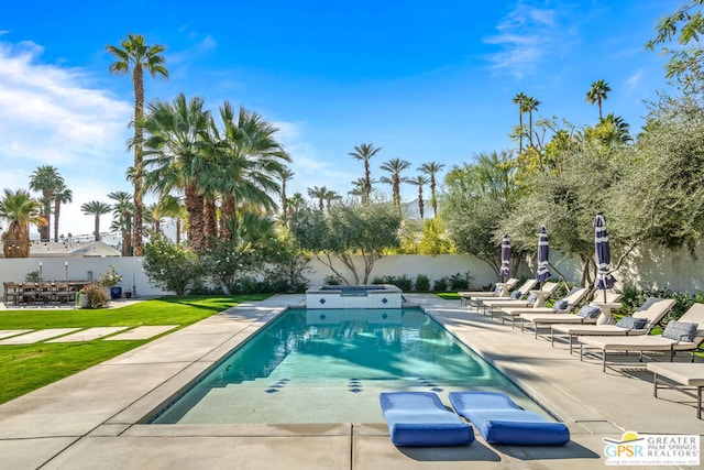 view of swimming pool featuring a lawn and a patio area