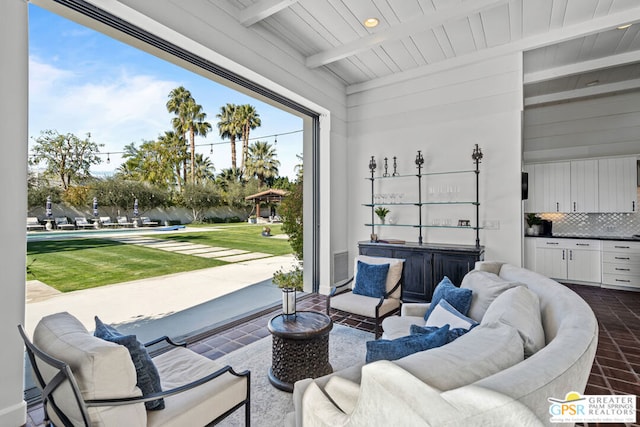 sunroom / solarium featuring beam ceiling