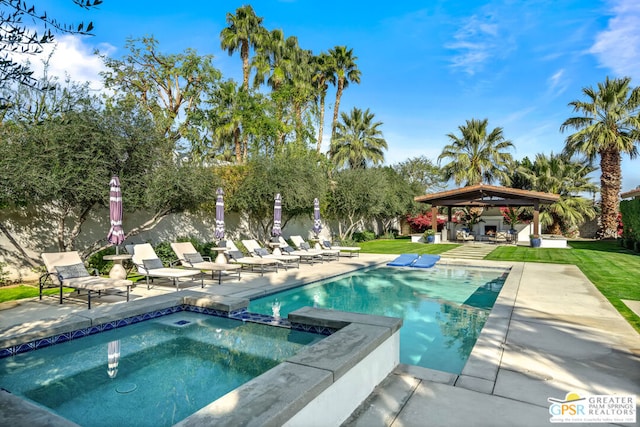 view of pool with a yard, a gazebo, a patio, and an in ground hot tub